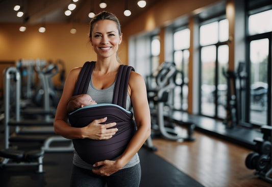 a woman in a gym holding her baby